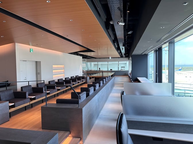 The POWER LOUNGE PREMIUM at Tokyo International Airport features spacious seating with airport views, offering a comfortable waiting area for travelers.