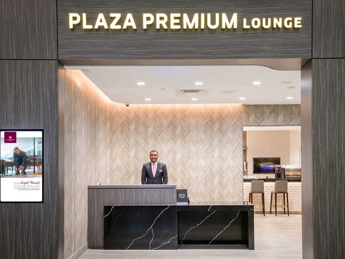 The entrance to the Plaza Premium Lounge at Toronto Pearson International Airport features a reception desk and visible seating area.