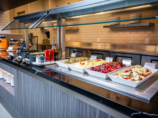 The Plaza Premium Lounge at Toronto Pearson International Airport features a self-serve buffet with a variety of salads and hot dishes.