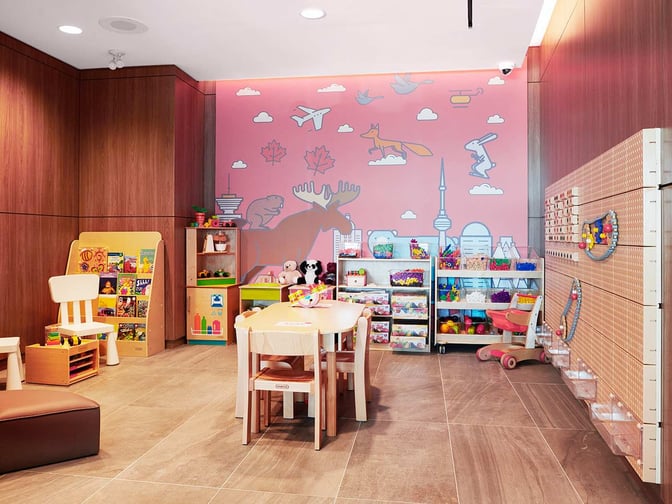 The children's play area in Plaza Premium Lounge at Toronto Pearson Airport features toys, books, and activity tables for young travelers.