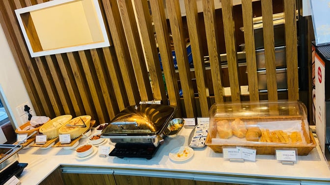 The food area in Thiruvananthapuram International Airport's domestic lounge offers a variety of breads and hot dishes for self-service.