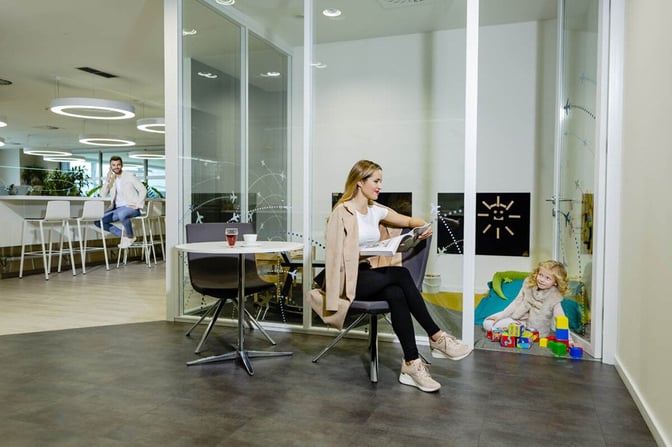 The Fast Track Lounge at Prague Vaclav Havel Airport features a seating area with tables and a visible children's playroom.