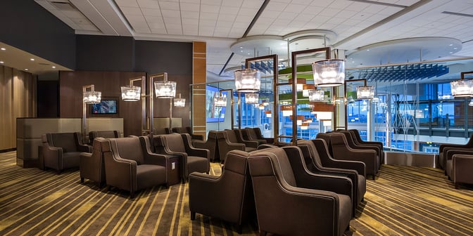 The seating area in Plaza Premium Lounge at Vancouver International Airport offers comfortable armchairs with views of the terminal.