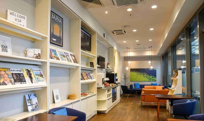 The VIP lounge at Varna Airport features a seating area with magazines, a self-serve snack station, and comfortable chairs.