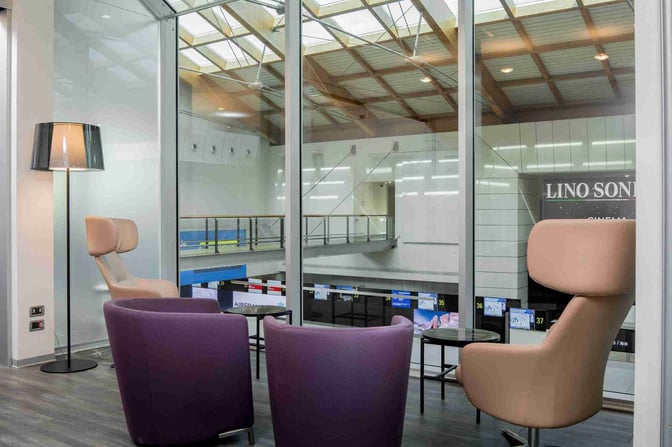 The Aspire Executive Lounge at Venice Marco Polo Airport features comfortable seating with views overlooking the terminal area.