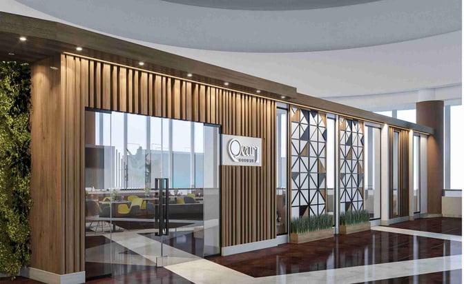 The entrance to the Pearl Lounge at Victoria Falls Airport features glass doors and a sign, leading to a seating area inside.