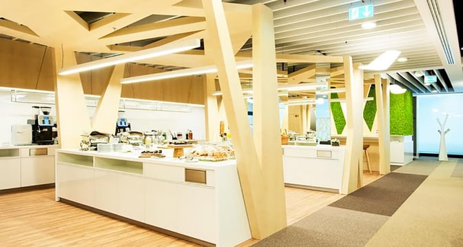 The Preludium Executive Lounge at Warsaw Chopin Airport features a self-serve food area with various snacks and beverages available.