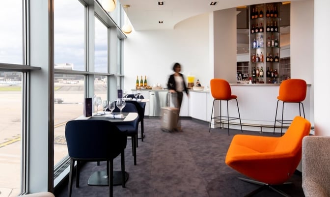 The Air France/KLM Lounge at Washington Dulles features a bar area with seating and a view of the airport runway.