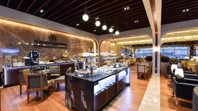 The Turkish Airlines Lounge at Washington Dulles International Airport features a self-serve food station with seating areas for dining and relaxation.
