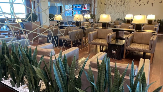 The Turkish Airlines Lounge at Washington Dulles features comfortable seating with tables, lamps, and a decorative partition for privacy.