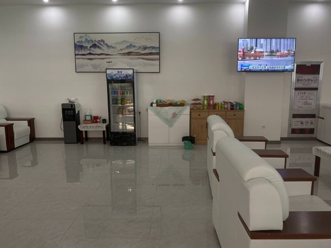 The Business VIP Lounge at Wuhu Xuanzhou Airport features a seating area with a snack station and a television for entertainment.