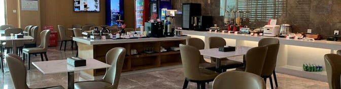 The China Southern First/Business Class Lounge at Wuhan Tianhe International Airport features a self-serve food and beverage area with ample seating.