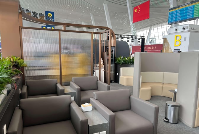 Seating area in the No. 1 VIP Reception at Wuhan Tianhe International Airport features armchairs and semi-private booths with power outlets.