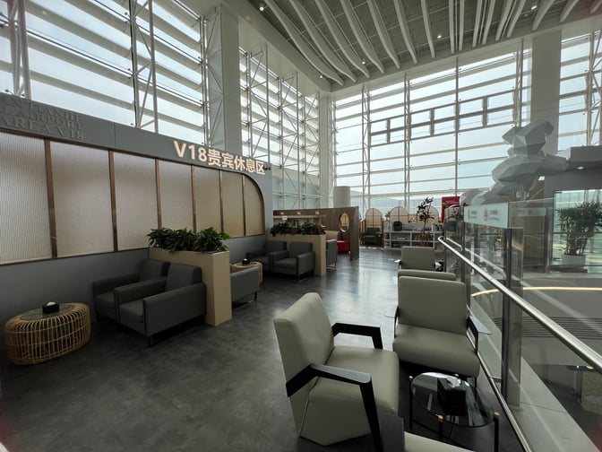 The V18 VIP Lounge at Wuhan Tianhe International Airport features comfortable seating areas with armchairs and tables for travelers.