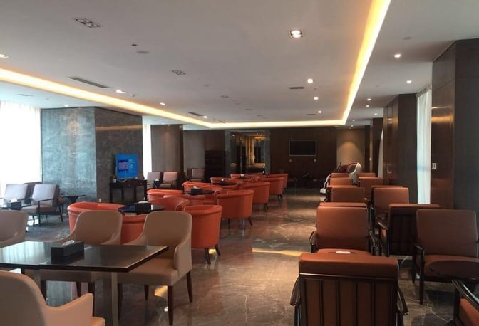 The First Class Lounge at Wuhan Tianhe International Airport features spacious seating areas with tables and armchairs for passenger comfort.