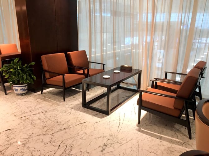 Seating area in the No. 6 Domestic First/Business Class Lounge at Wuhan Tianhe International Airport features armchairs and a central table.