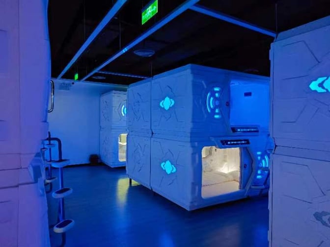 The nap pod area at Wuhan Tianhe International Airport features stacked sleep pods with illuminated control panels for passenger rest.