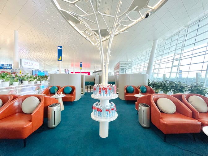 The VIP Reception No.1 lounge at Wuhan Tianhe International Airport features seating areas with round tables and complimentary bottled water.