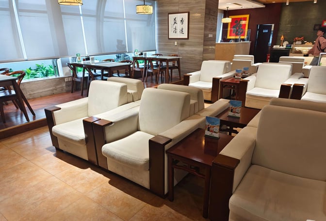 The seating area in First Class Lounge No. 3 at Xi'an Xianyang International Airport features comfortable armchairs and tables for relaxation.
