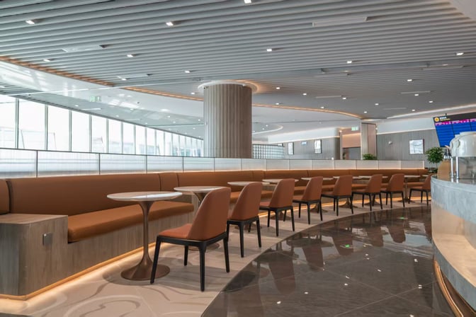 The seating area in China Eastern Lounge at Xi'an Xianyang International Airport features booth seating with tables and chairs for travelers.