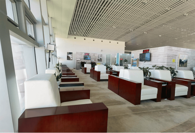 Seating in the First Class Lounge at Xingyi Wanfenglin Airport features individual armchairs with side tables, offering a comfortable waiting area.