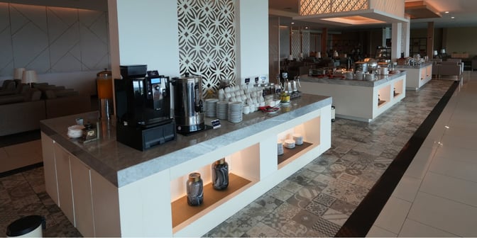 The Concordia Lounge at Yogyakarta International Airport features a self-serve beverage station with coffee, tea, and juice options.