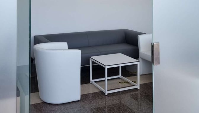 The seating area in Zadar Airport Business Lounge features a sofa, armchairs, and a central table for passenger comfort.