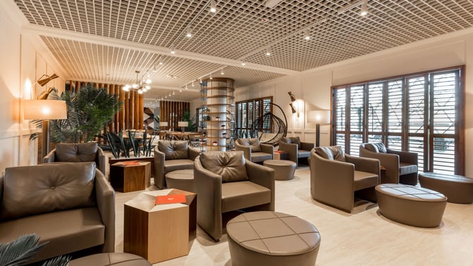 The Primeclass Lounge at Zagreb Airport features comfortable seating with armchairs and tables, providing a relaxing space for travelers.