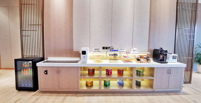 The snack station in the No. 1 VIP Lounge Landside at Zhangjiajie Hehua Airport offers a selection of beverages and packaged snacks.