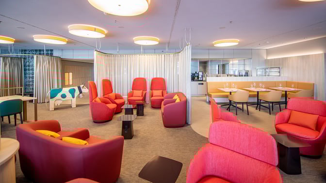 The marhaba Lounge at Zurich Airport features comfortable seating areas with armchairs and tables, alongside a dining section with booth seating.