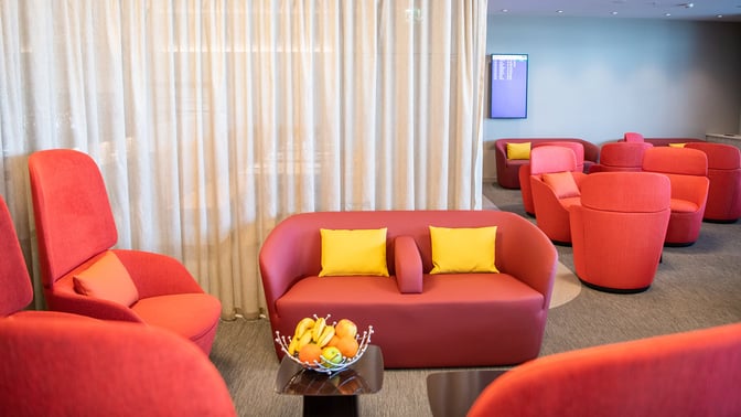 The marhaba Lounge at Zurich Airport features comfortable seating with armchairs and sofas, and a table with a fruit bowl.