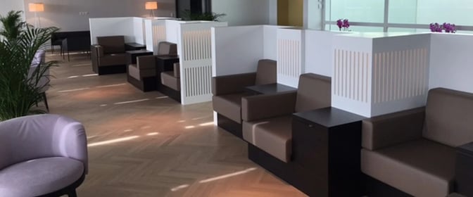 The Aspire Lounge at Zurich Airport features semi-private seating with partitioned booths and tables for passenger comfort and privacy.