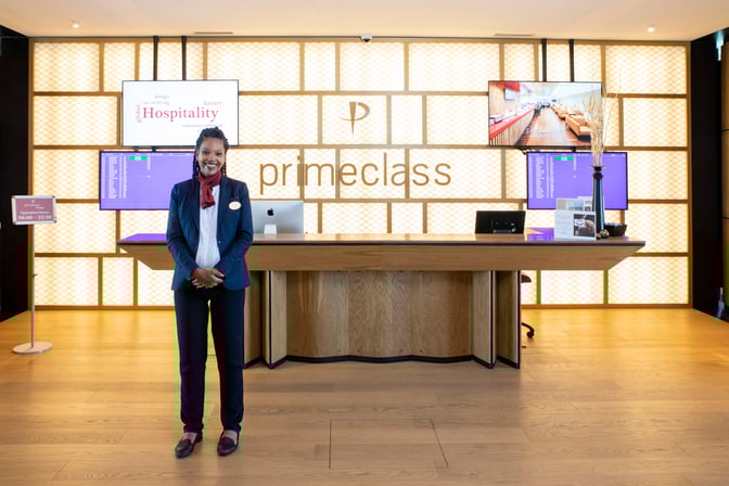 The Primeclass Lounge reception at Zurich Airport features a staffed service desk with flight information displays and operational hours signage.