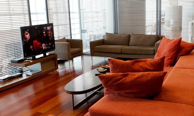 The seating area in the Converse Bank Business Lounge features comfortable sofas and a television for passenger entertainment at Zvartnots Airport.